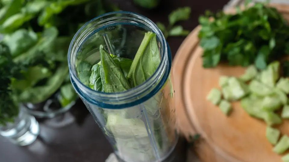 Sleek health supplement bottles, smart ring, and glass of filtered water on marble counter